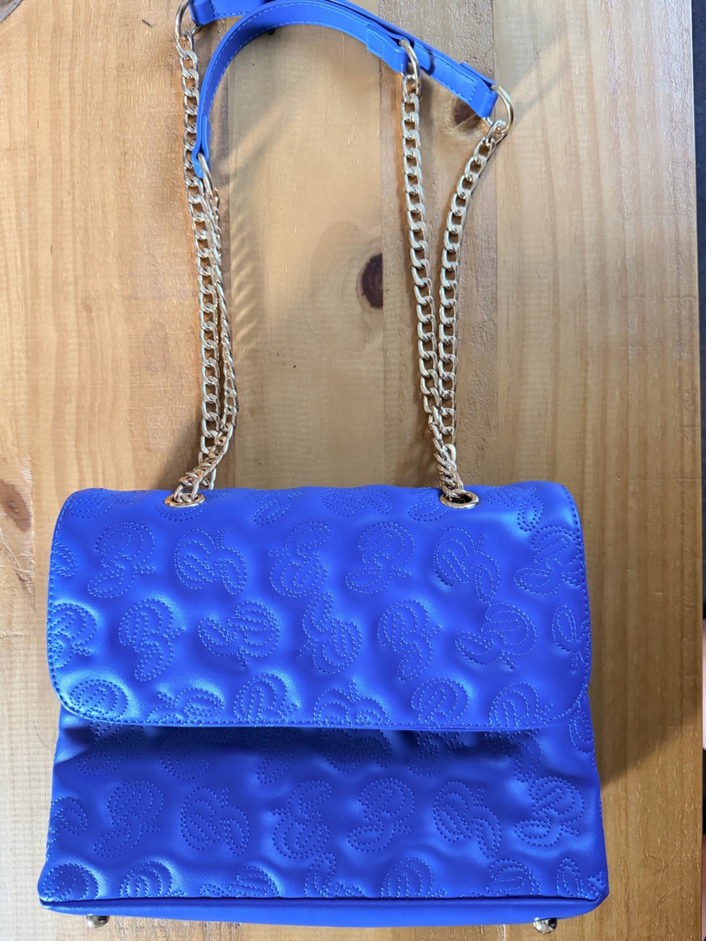Bink & Bougie Blue quilted chain‎ bag with a monogram pattern.